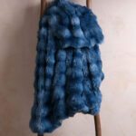 Tie-dye blue bubble bunny faux fur blanket draped over wooden ladder, soft fuzzy bedding