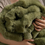 Soft hug shot of sage green bubble bunny fluffy faux fur blanket, ultra cozy plush bedding