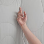 Light Gray Cooling Blanket Touch Shot, Soft Breathable Fabric Texture